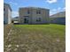The backyard features a green lawn with solar panels on the roof, and a sliding glass door at 1114 Brimstone Cir, Winter Haven, FL 33884