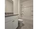 The bathroom features a shower over tub, gray tile floors, and a vanity with a solid surface counter at 1114 Brimstone Cir, Winter Haven, FL 33884