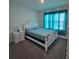 Bright bedroom featuring a bed with white frame and a large window with curtains at 1114 Brimstone Cir, Winter Haven, FL 33884