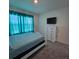 Cozy bedroom with a large window, dresser, and a comfortable bed at 1114 Brimstone Cir, Winter Haven, FL 33884