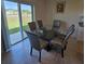Bright dining area featuring a glass table, comfortable seating, and sliding glass doors to the back at 1114 Brimstone Cir, Winter Haven, FL 33884