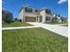 Two-story home featuring a spacious two car garage and a well manicured lawn at 1114 Brimstone Cir, Winter Haven, FL 33884