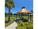 Scenic gazebo overlooking a tranquil pond, creating a peaceful setting for outdoor enjoyment at 1114 Brimstone Cir, Winter Haven, FL 33884