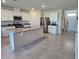 Modern kitchen with stainless steel appliances, a central island, and tile flooring at 1114 Brimstone Cir, Winter Haven, FL 33884