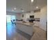 Bright eat-in kitchen with stainless appliances, a large island, and sliding glass doors to the back at 1114 Brimstone Cir, Winter Haven, FL 33884