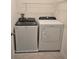 Convenient laundry room featuring a Whirlpool washer and dryer, with ample storage shelving above at 1114 Brimstone Cir, Winter Haven, FL 33884