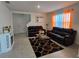 Comfortable living room with tile flooring, cozy seating, and lots of natural light at 1114 Brimstone Cir, Winter Haven, FL 33884