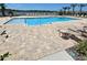 Community pool area featuring ample seating and a tranquil lake view, perfect for relaxing and enjoying the Florida sunshine at 1114 Brimstone Cir, Winter Haven, FL 33884