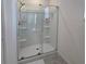 Modern shower with clear glass doors, built-in shelves, and sleek fixtures at 1114 Brimstone Cir, Winter Haven, FL 33884