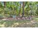 Scenic backyard with lush greenery, a charming fence, and decorative elements at 11569 Sw 75Th Cir, Ocala, FL 34476