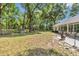Extensive backyard featuring lush greenery, patio area, and a glimpse of the home at 11569 Sw 75Th Cir, Ocala, FL 34476