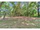 Lush backyard featuring mature trees, open space, and a charming wooden fence at 11569 Sw 75Th Cir, Ocala, FL 34476
