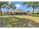 Spacious backyard with manicured lawn, patio seating, and view of rear exterior at 11569 Sw 75Th Cir, Ocala, FL 34476