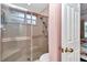 A shower stall with sliding glass doors and a built-in seat is next to the door at 11569 Sw 75Th Cir, Ocala, FL 34476