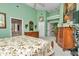 Spacious main bedroom with wood furniture and a ceiling fan, featuring a green color scheme at 11569 Sw 75Th Cir, Ocala, FL 34476
