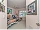 A bedroom with two twin beds, a ceiling fan, and shuttered windows at 11569 Sw 75Th Cir, Ocala, FL 34476