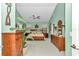 Spacious main bedroom with wood furniture and a ceiling fan, featuring a green color scheme at 11569 Sw 75Th Cir, Ocala, FL 34476