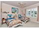 A bedroom with two twin beds, a ceiling fan, and shuttered windows at 11569 Sw 75Th Cir, Ocala, FL 34476