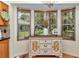 Dining room cabinet with accent lighting, drawers, and decorative details, with a view of the yard at 11569 Sw 75Th Cir, Ocala, FL 34476