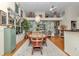 A bright dining room features a chandelier, hardwood floors, a wooden table, and an ornate accent wall at 11569 Sw 75Th Cir, Ocala, FL 34476
