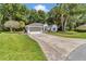 Charming single-story home featuring a well-manicured lawn and a welcoming two-car garage with paved driveway at 11569 Sw 75Th Cir, Ocala, FL 34476