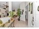 Inviting foyer with tile flooring, decorative plants, console table, and art leading to the living spaces at 11569 Sw 75Th Cir, Ocala, FL 34476