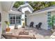 Inviting front entrance featuring an outdoor seating area with wicker furniture and a beautifully brick paved walkway at 11569 Sw 75Th Cir, Ocala, FL 34476