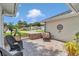 Inviting front entrance featuring an outdoor seating area, iron gate and brick paved walkway at 11569 Sw 75Th Cir, Ocala, FL 34476