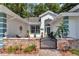 Inviting front entrance featuring an outdoor seating area, iron gate, and a beautifully landscaped walkway at 11569 Sw 75Th Cir, Ocala, FL 34476