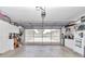 A spacious two car garage is set up with storage cabinets and an epoxy floor at 11569 Sw 75Th Cir, Ocala, FL 34476