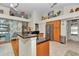 Spacious kitchen showcasing wood cabinetry, stainless appliances, granite countertops, and a center island sink at 11569 Sw 75Th Cir, Ocala, FL 34476