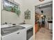 Modern laundry room with Maytag washer and dryer, adjacent to the kitchen at 11569 Sw 75Th Cir, Ocala, FL 34476