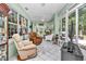 Inviting sunroom with comfortable seating and views of the lush outdoor scenery at 11569 Sw 75Th Cir, Ocala, FL 34476