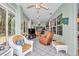 Relaxing sunroom with tile flooring and plush seating, perfect for year-round enjoyment at 11569 Sw 75Th Cir, Ocala, FL 34476