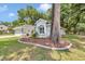 Side yard featuring mature landscaping and a large shade tree at 11569 Sw 75Th Cir, Ocala, FL 34476