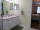 Bathroom featuring a sink with a pink countertop and a view into the bedroom at 11628 Sw 140Th Loop, Dunnellon, FL 34432