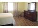Cozy bedroom with a dresser, mirror, and warm-toned decor at 11628 Sw 140Th Loop, Dunnellon, FL 34432