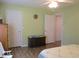 Cozy bedroom features a ceiling fan, wood-look flooring, and a charming decorative chest at 11628 Sw 140Th Loop, Dunnellon, FL 34432