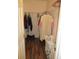Walk-in closet with hanging clothes, wood-look flooring, and storage space at 11628 Sw 140Th Loop, Dunnellon, FL 34432