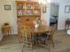 Charming dining area with wood table, chairs, hutch, and modern flooring at 11628 Sw 140Th Loop, Dunnellon, FL 34432