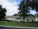 Charming single-story home with a well-manicured front lawn and lush landscaping at 11628 Sw 140Th Loop, Dunnellon, FL 34432