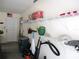 Garage with shelves, storage containers, tools, and door to outside at 11628 Sw 140Th Loop, Dunnellon, FL 34432