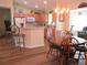 Eat-in kitchen with wood cabinets, island with bar seating, and a wood dining table at 11628 Sw 140Th Loop, Dunnellon, FL 34432