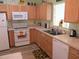 Bright kitchen featuring updated appliances, spacious countertops, and a convenient layout at 11628 Sw 140Th Loop, Dunnellon, FL 34432