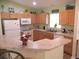 Charming kitchen with bright cabinets, modern appliances, and plenty of counter space for meal preparation at 11628 Sw 140Th Loop, Dunnellon, FL 34432