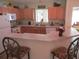 Cozy kitchen features wood cabinets, white appliances, and a breakfast bar with seating at 11628 Sw 140Th Loop, Dunnellon, FL 34432
