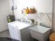 Laundry area with a washer, dryer, utility sink and storage shelf at 11628 Sw 140Th Loop, Dunnellon, FL 34432