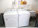 Laundry area with a washer, dryer, utility sink and storage shelf at 11628 Sw 140Th Loop, Dunnellon, FL 34432