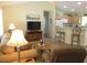 Inviting living room featuring a cozy sofa, TV, and an open layout to the kitchen at 11628 Sw 140Th Loop, Dunnellon, FL 34432