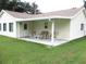 Enjoy outdoor living on this covered patio with comfortable seating and serene backyard views at 11628 Sw 140Th Loop, Dunnellon, FL 34432